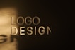 The image features the words 'LOGO DESIGN' in large, bold letters against a dark background, with a spotlight creating a shadow effect on the wall.