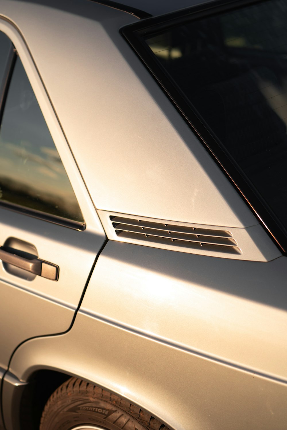 a close up of a parked car with a sky background