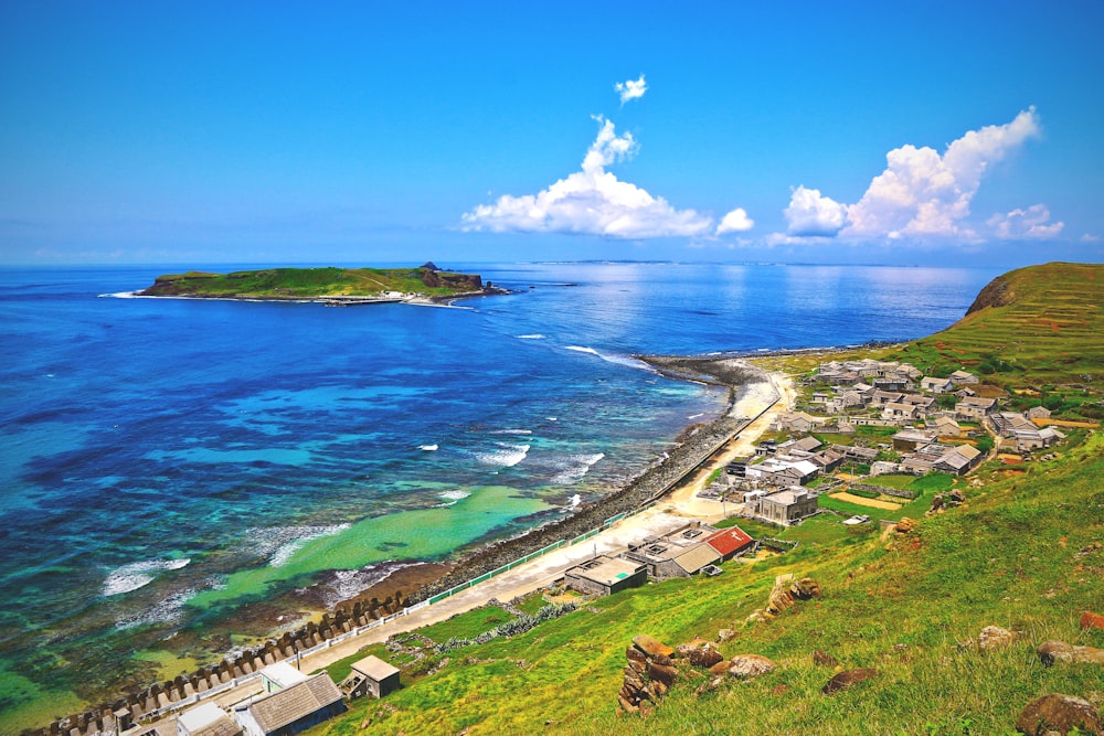 an aerial view of a small village by the ocean