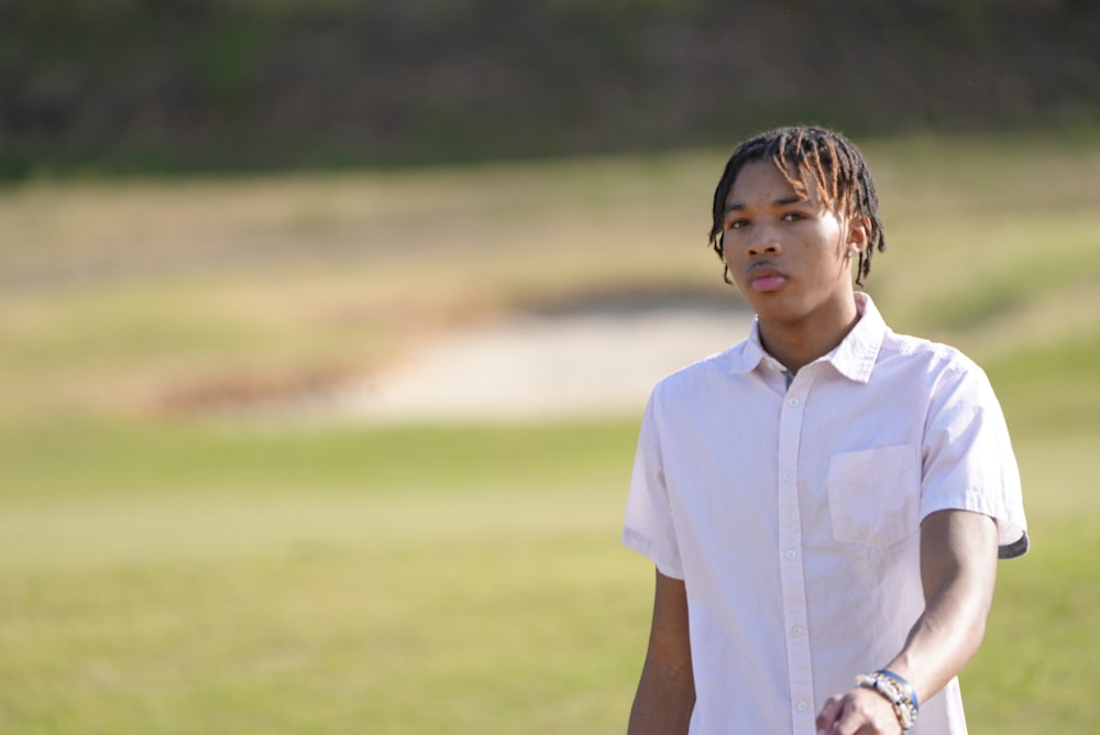 a man standing in a field with a frisbee in his hand