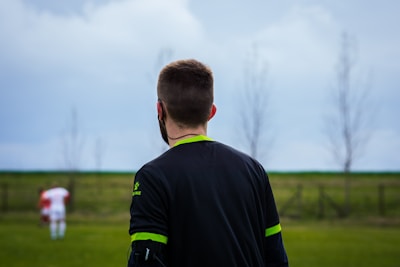 a man standing in a field with a frisbee in his hand