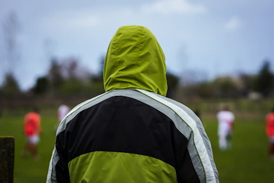 The agent watching an intense football match from the sidelines.