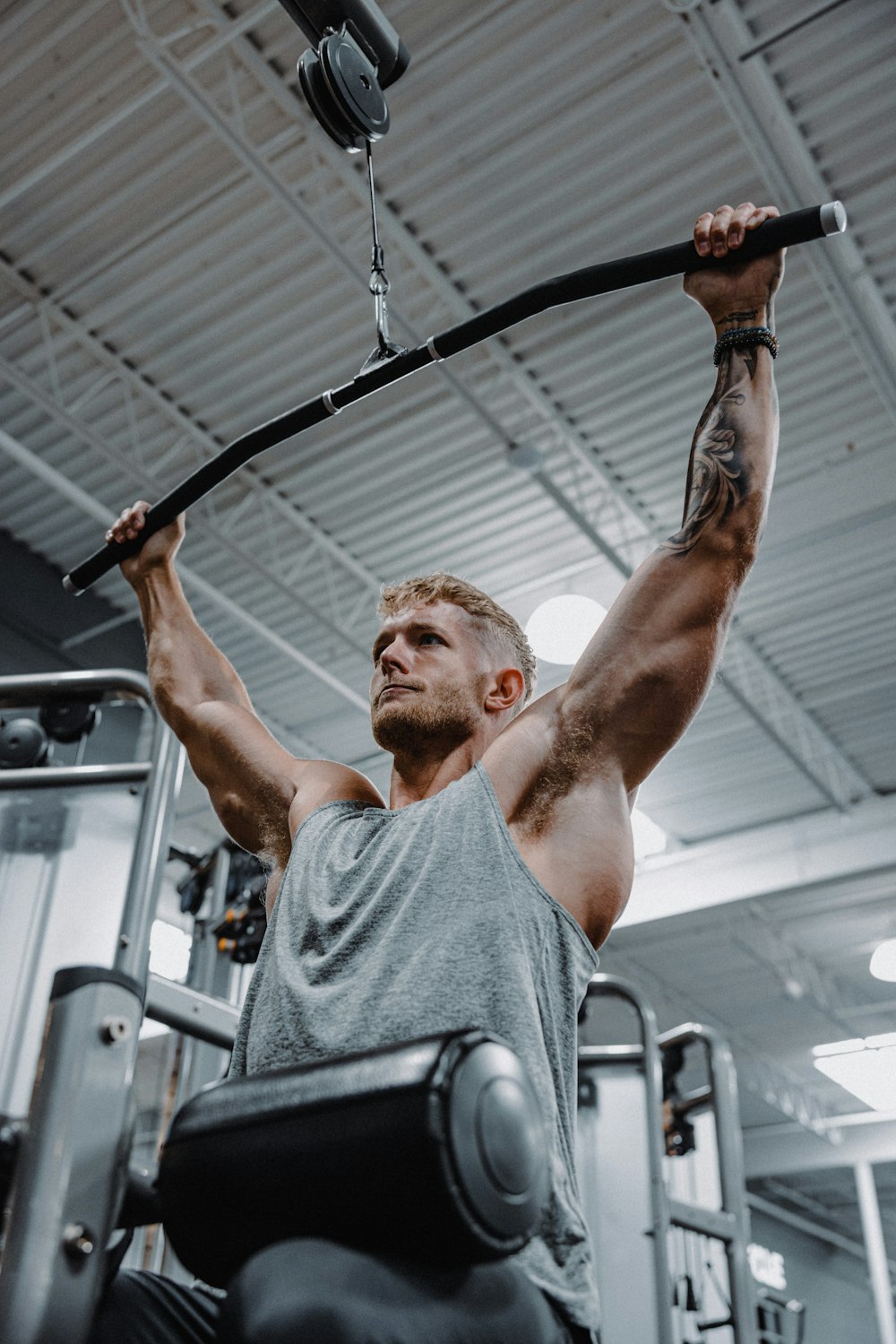 a man in a gym lifting a bar