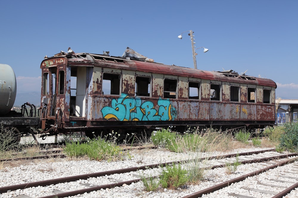 an old abandoned train car with graffiti on it