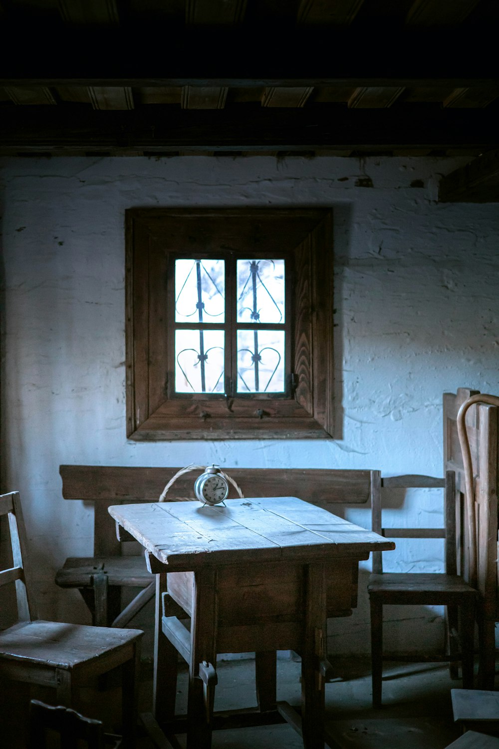 a table and chairs in a room with a window