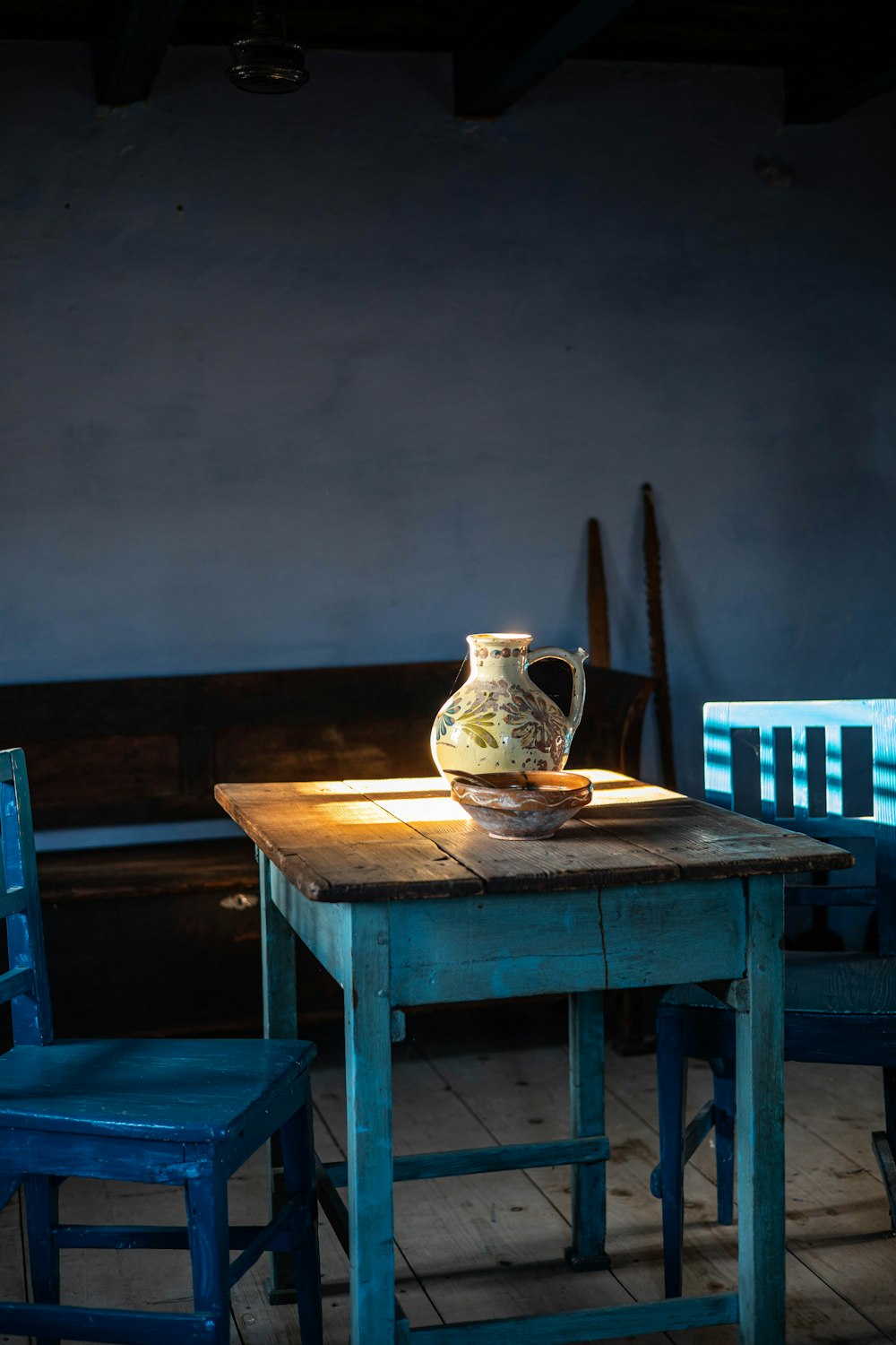 a wooden table with a vase on top of it