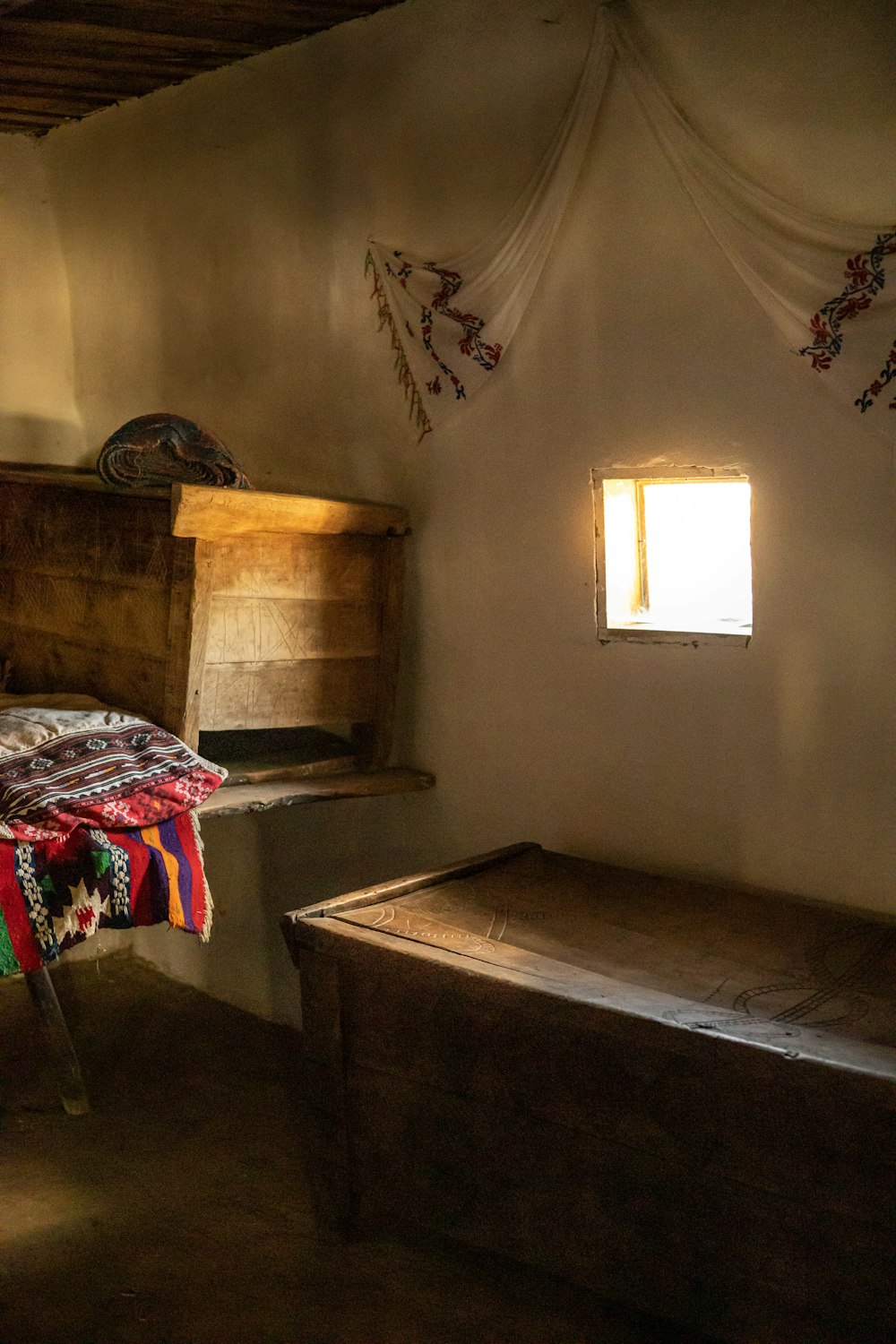 a room with a bed and a bench in it