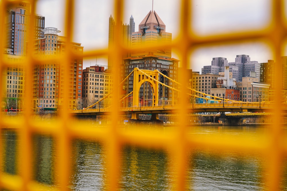 a view of a bridge through a yellow fence