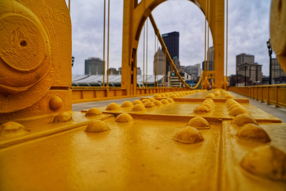 a view of a yellow bridge with a building in the background