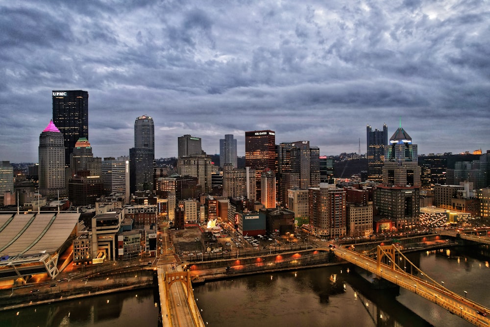 a view of a city at night with a bridge in the foreground