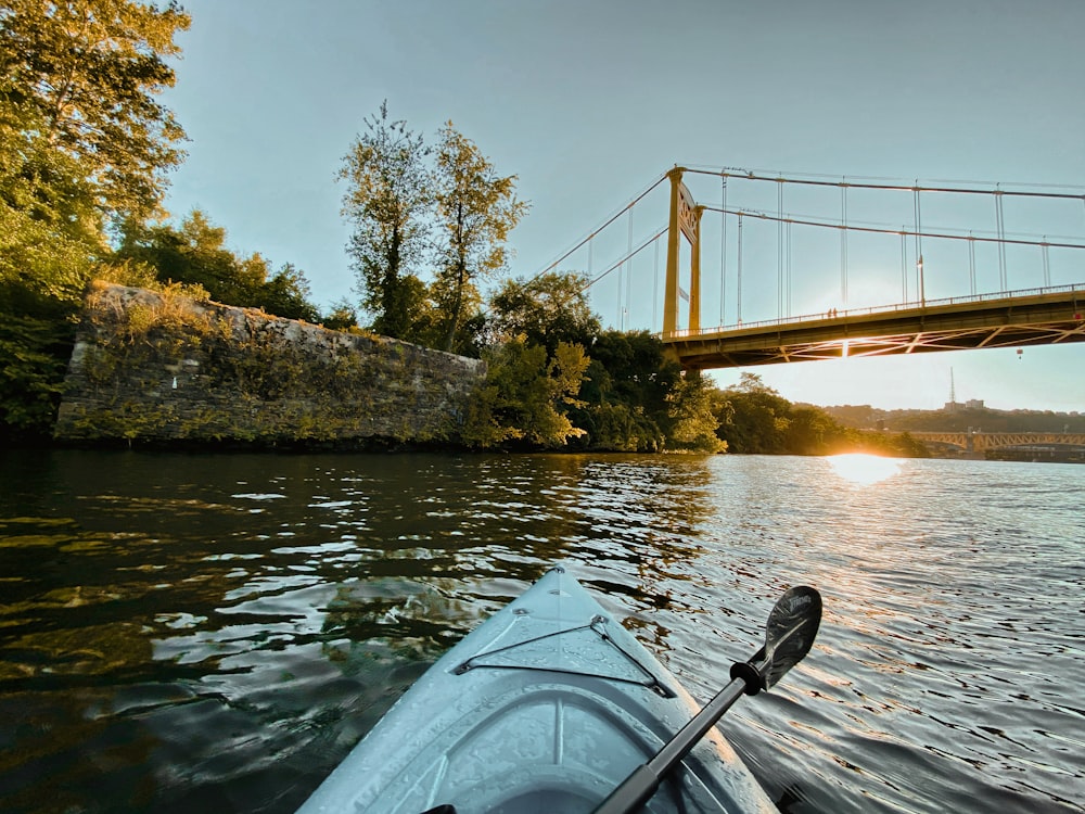 a view of a bridge over a river from a kayak