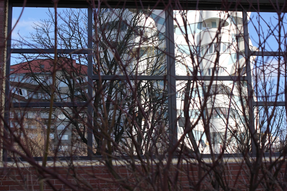 a clock tower seen through a window of a building