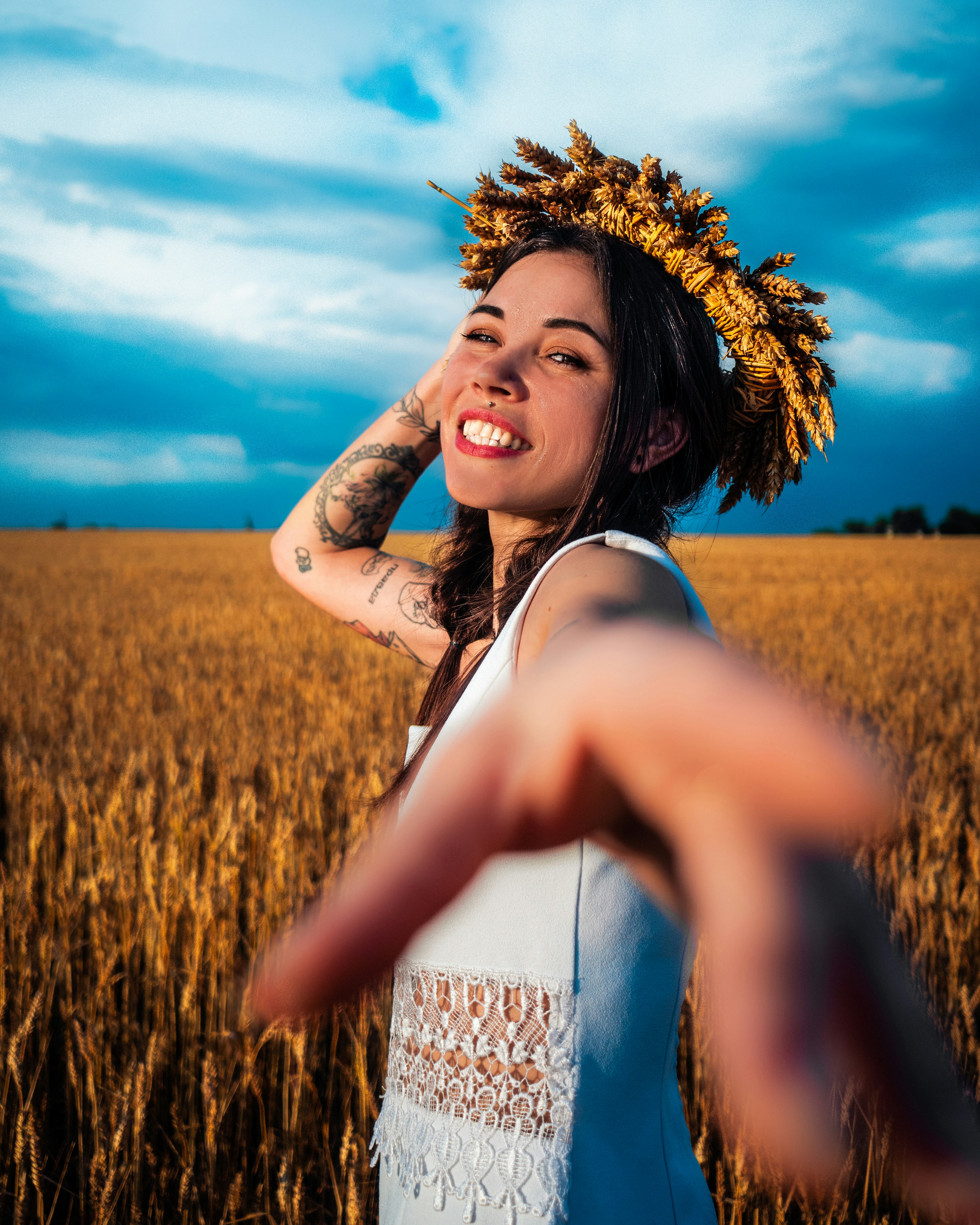 a woman standing in a field with her arms out