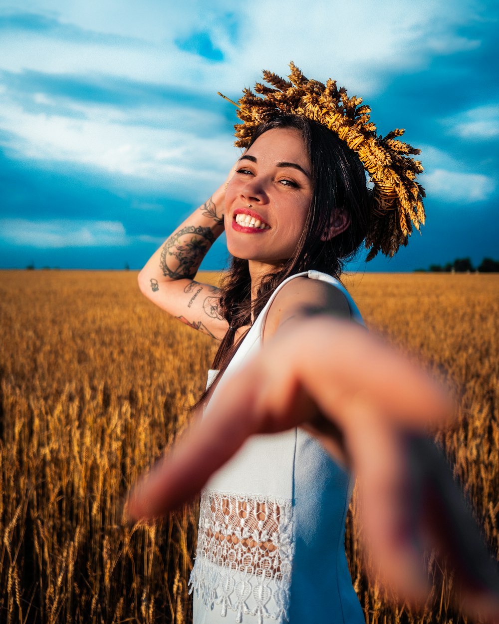 a woman standing in a field with her arms out