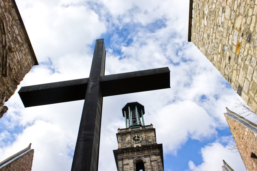 a large cross in the middle of some buildings