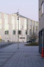 an empty sidewalk in front of a building