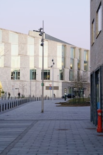 an empty sidewalk in front of a building