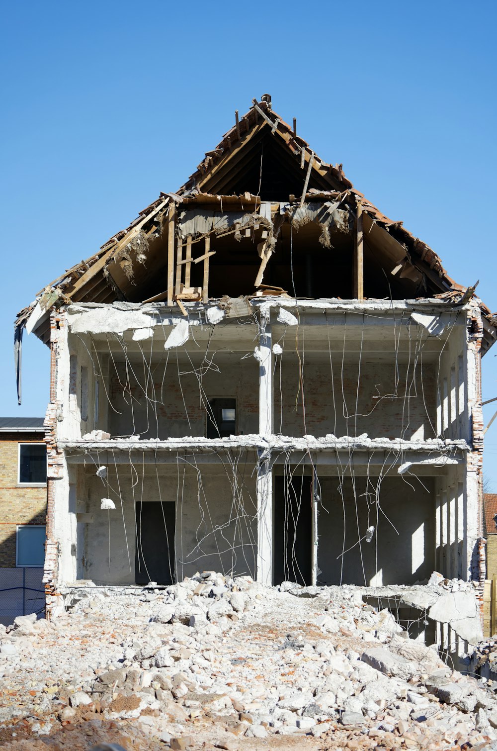 a house under construction with the roof torn off