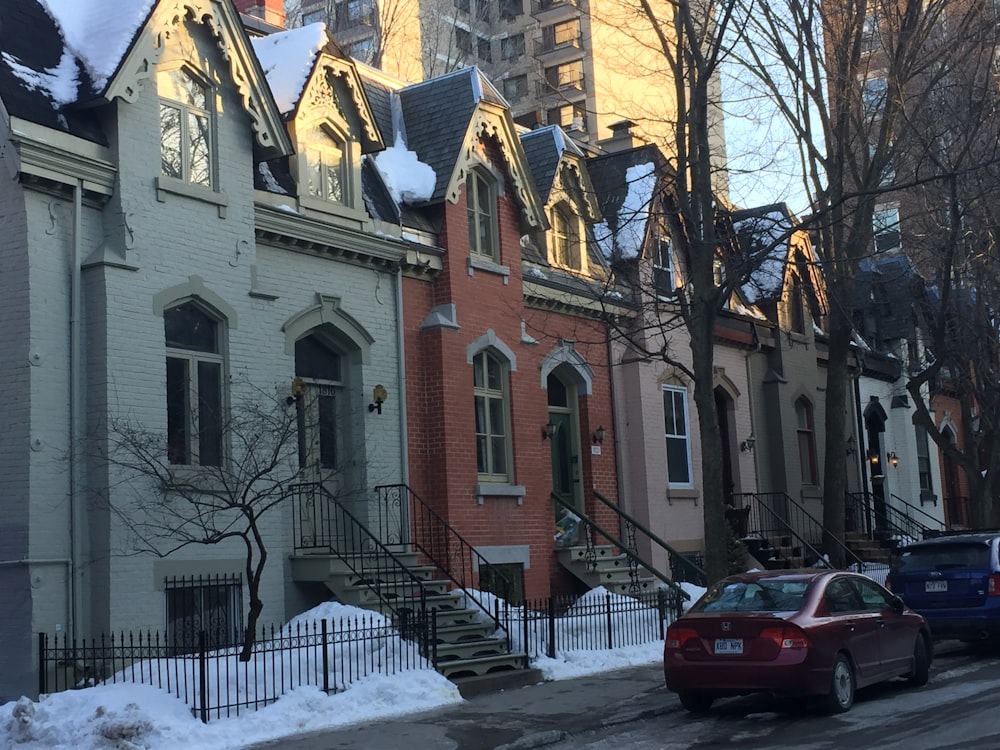 a row of houses with snow on the ground