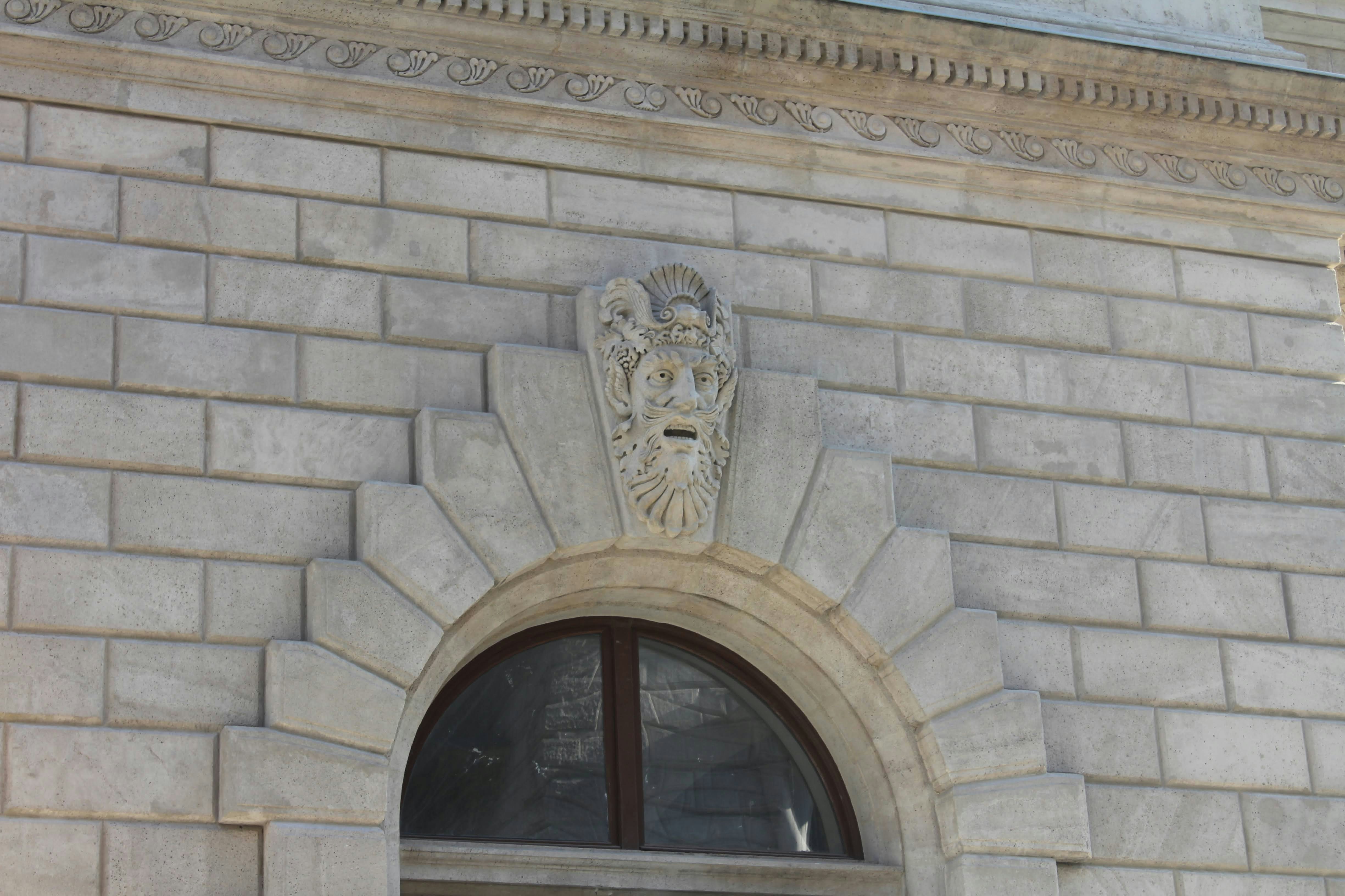 a stone building with a clock on the front of it