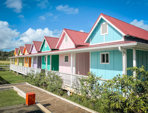 a row of multicolored houses with a wooden deck