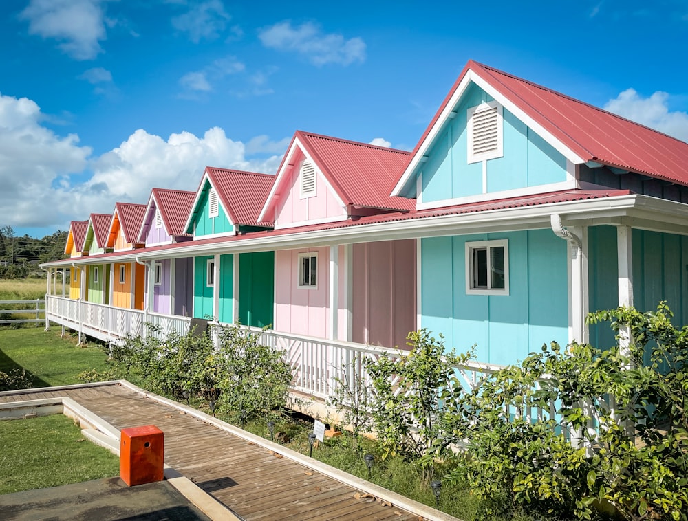 a row of multicolored houses with a wooden deck