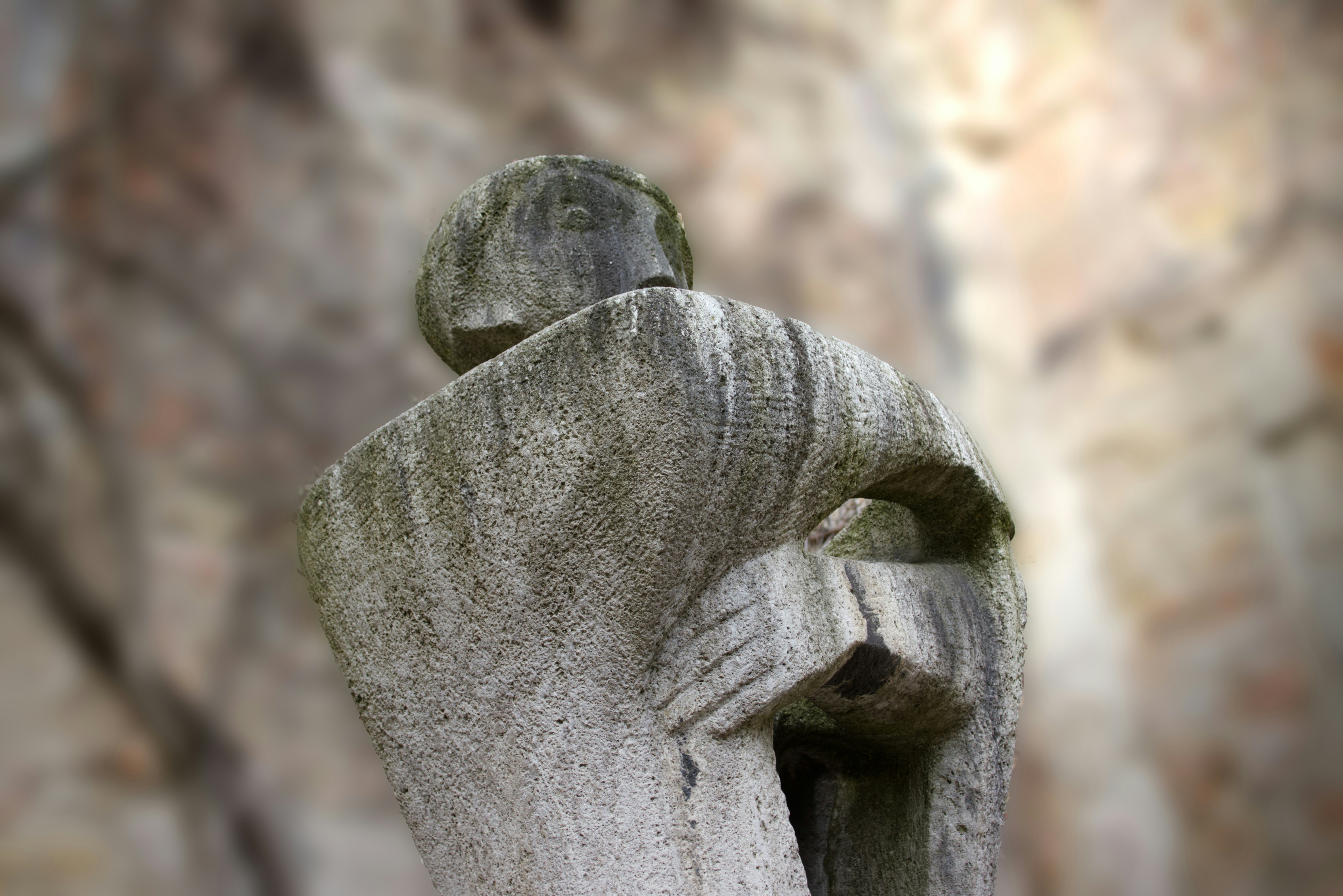 a statue of a person with their arms wrapped around him