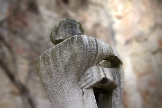 a statue of a person with their arms wrapped around him