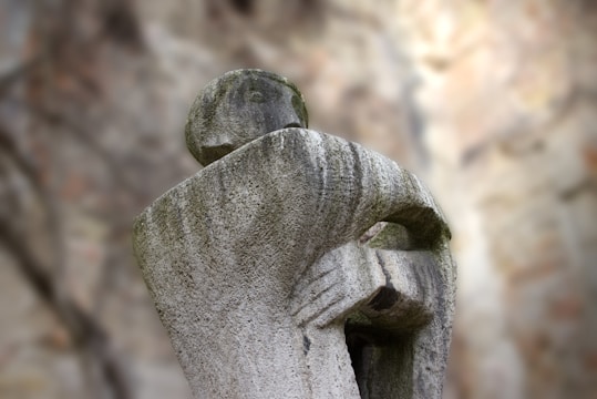 a statue of a person with their arms wrapped around him