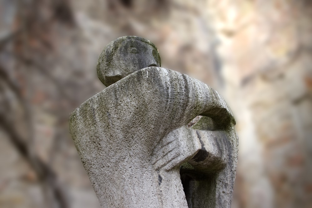 a statue of a person with their arms wrapped around him