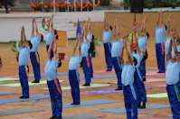 a group of people standing in a line doing yoga