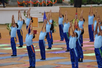 a group of people standing in a line doing yoga