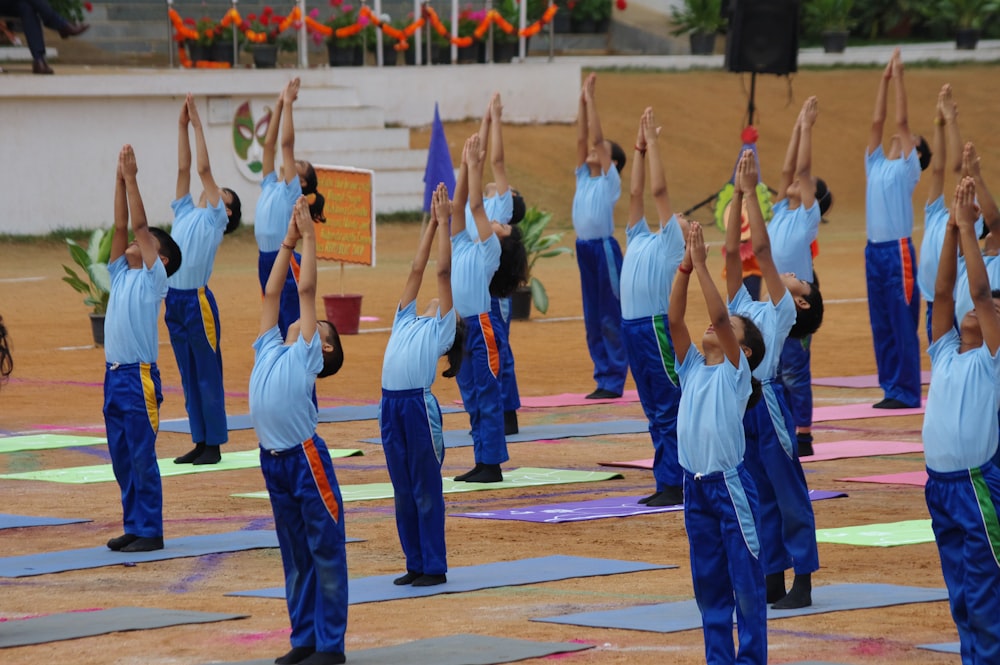 a group of people standing in a line doing yoga