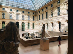 a large building with a glass ceiling and a statue in the center