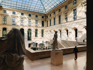 a large building with a glass ceiling and a statue in the center
