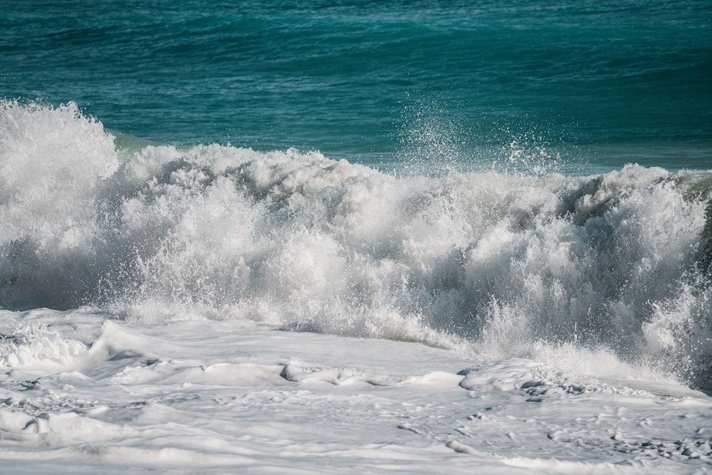 a man riding a wave on top of a surfboard