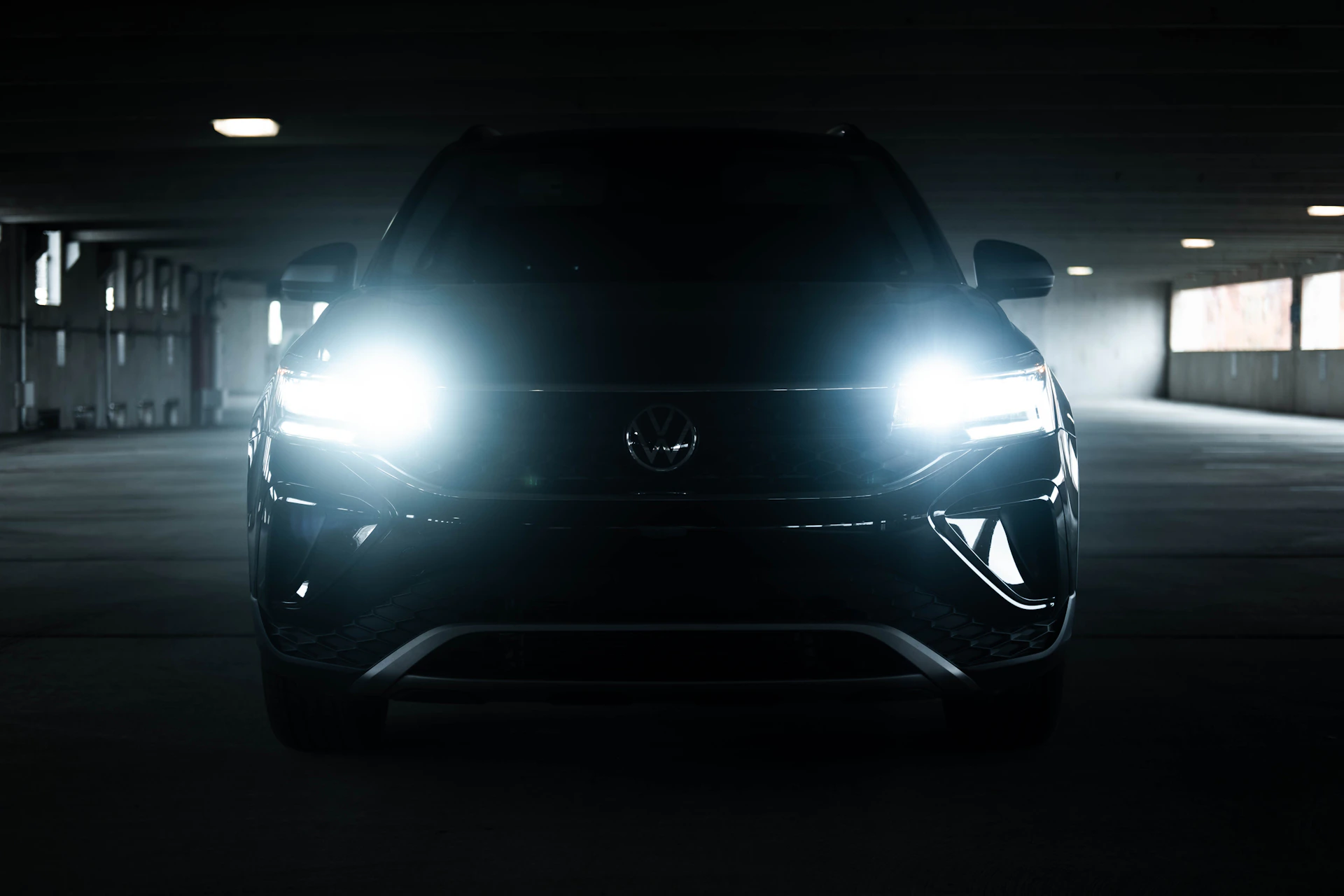 the front of a black car in a parking garage