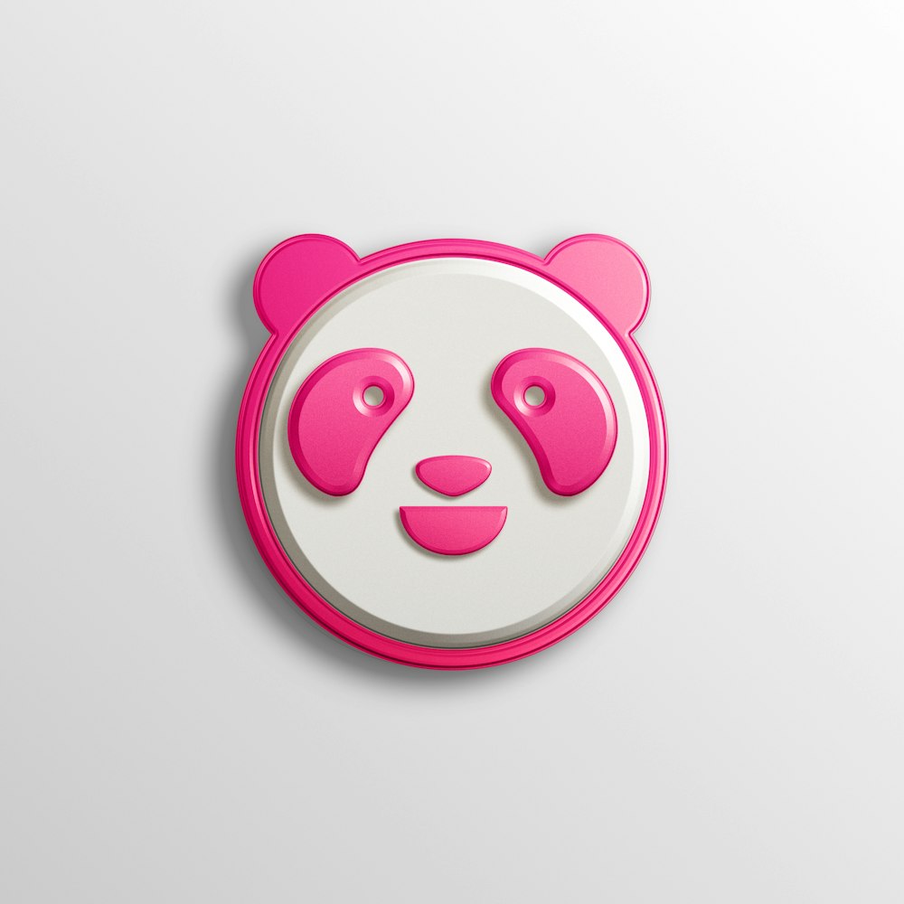 a pink and white panda face on a white background