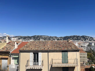 Panoramic view of Sestu town with clear blue sky and community gathering in the foreground.