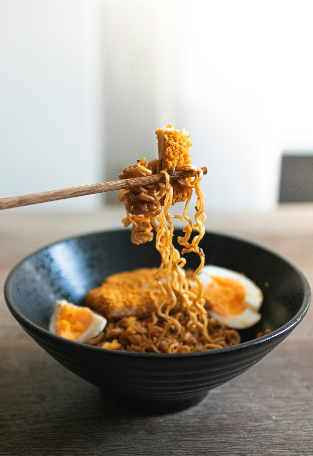 a bowl of ramen with chopsticks sticking out of it