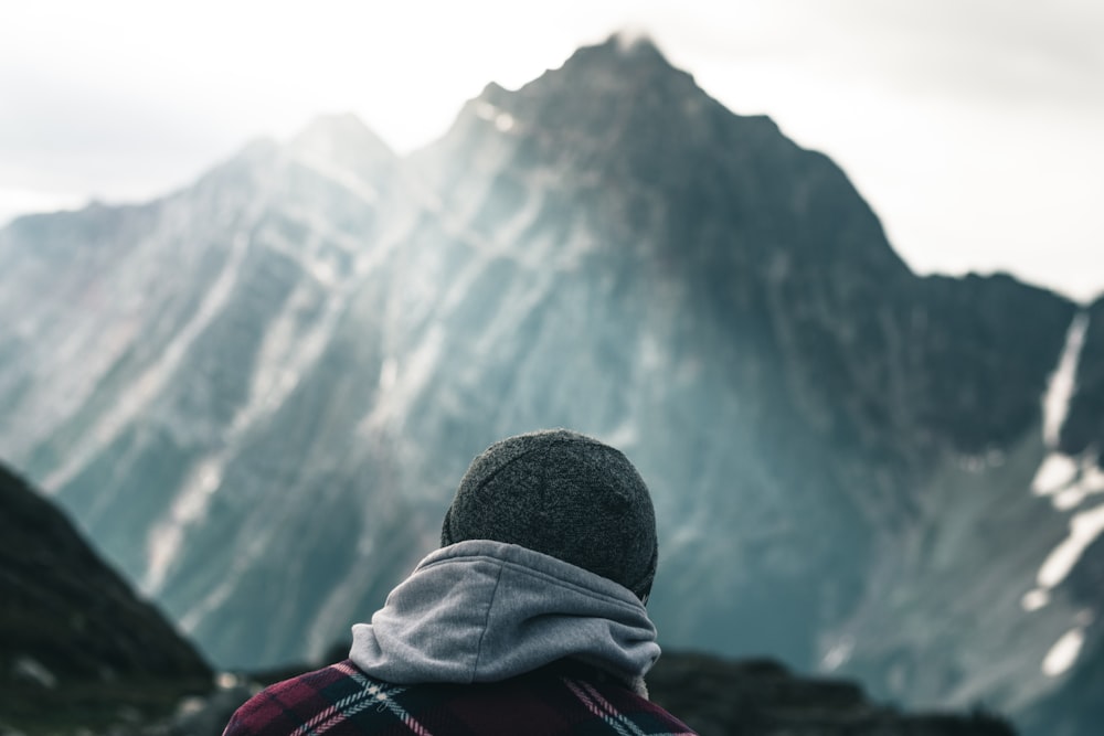 a person standing in front of a mountain range