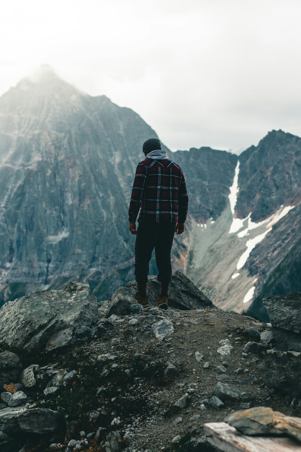 a man standing on top of a rocky mountain