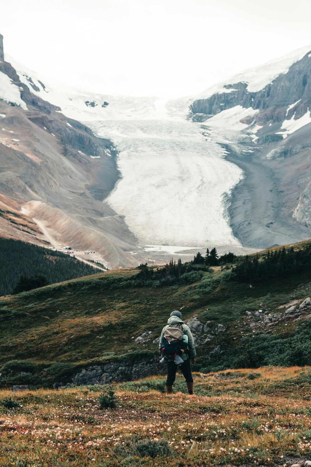 a person with a backpack walking up a hill