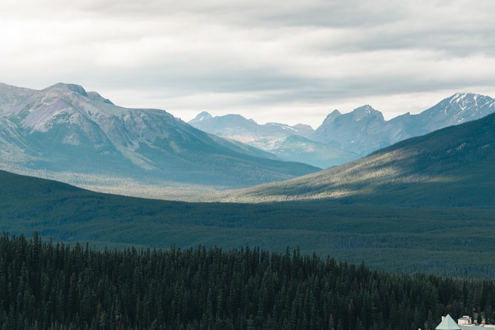 a view of a mountain range with a house in the foreground