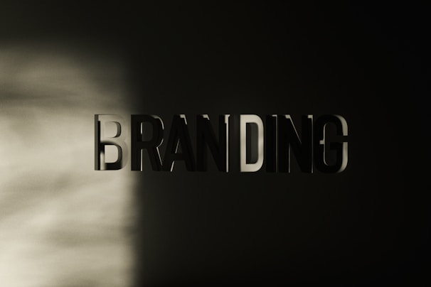 The word 'BRANDING' appears in large, bold, three-dimensional letters against a dark background, with a soft light casting shadows across the left side.