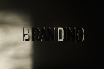The word 'BRANDING' appears in large, bold, three-dimensional letters against a dark background, with a soft light casting shadows across the left side.