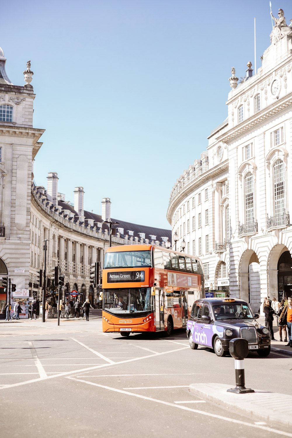 a double decker bus driving down a city street