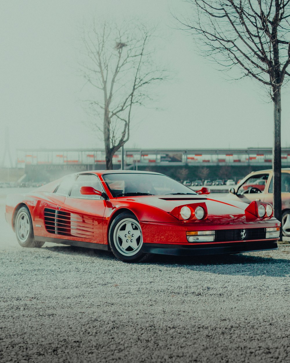 a red sports car parked in a parking lot