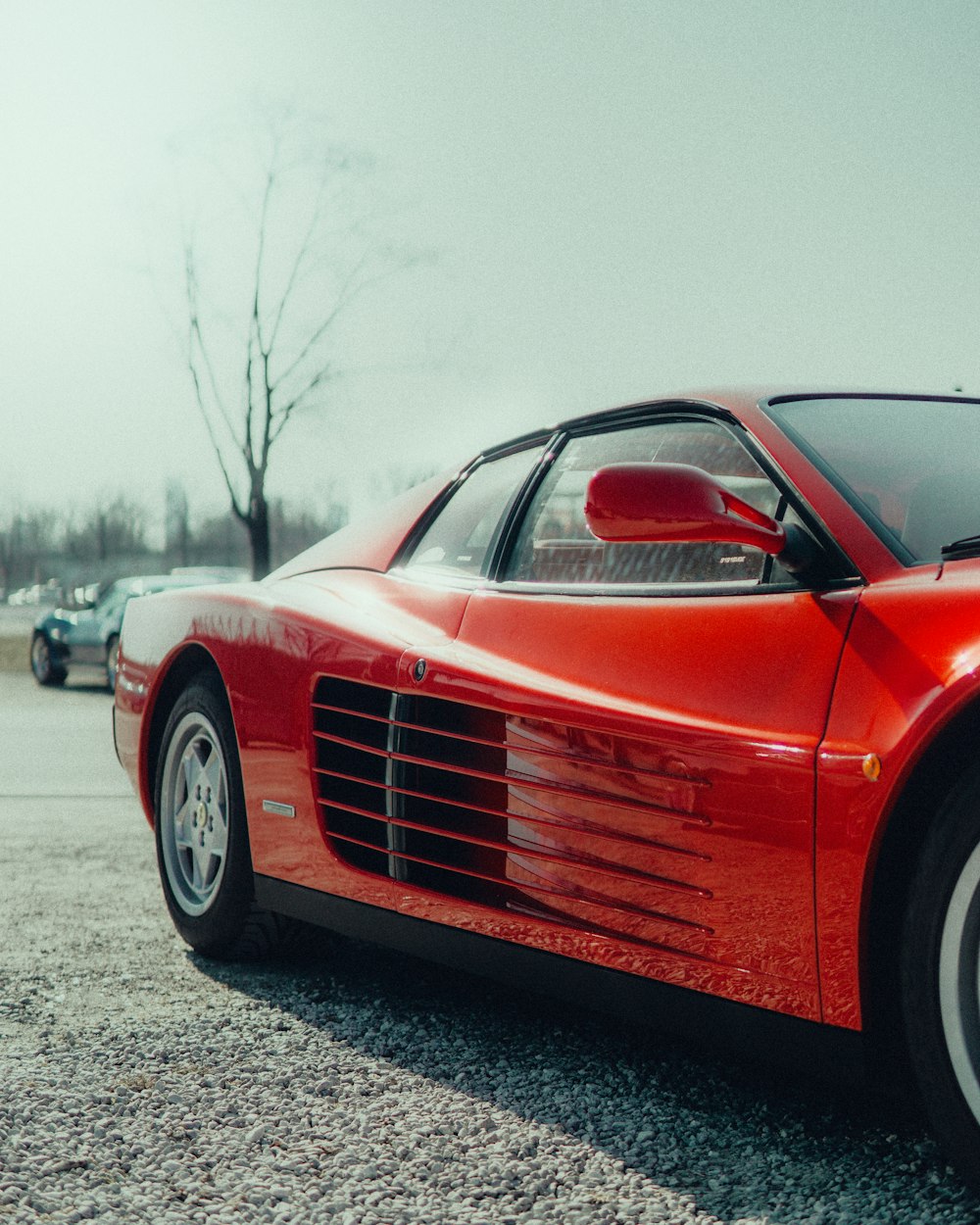 a red sports car parked in a parking lot