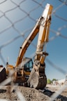 a large construction vehicle sitting on top of a dirt field